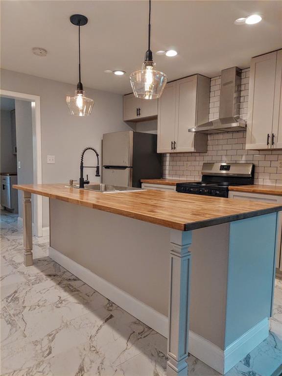 a kitchen with kitchen island granite countertop a sink cabinets and stainless steel appliances