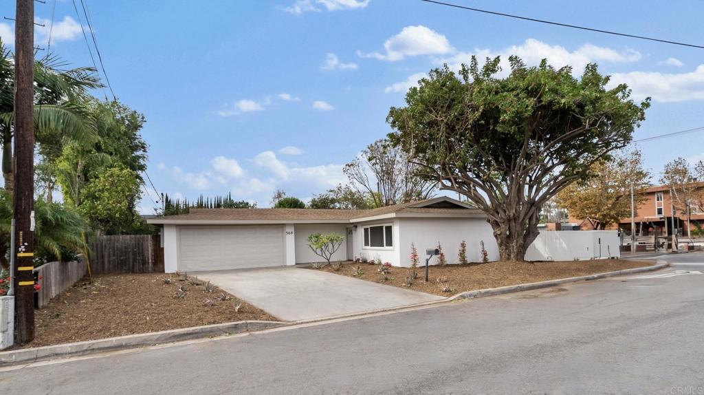 front view of a house with a dry trees