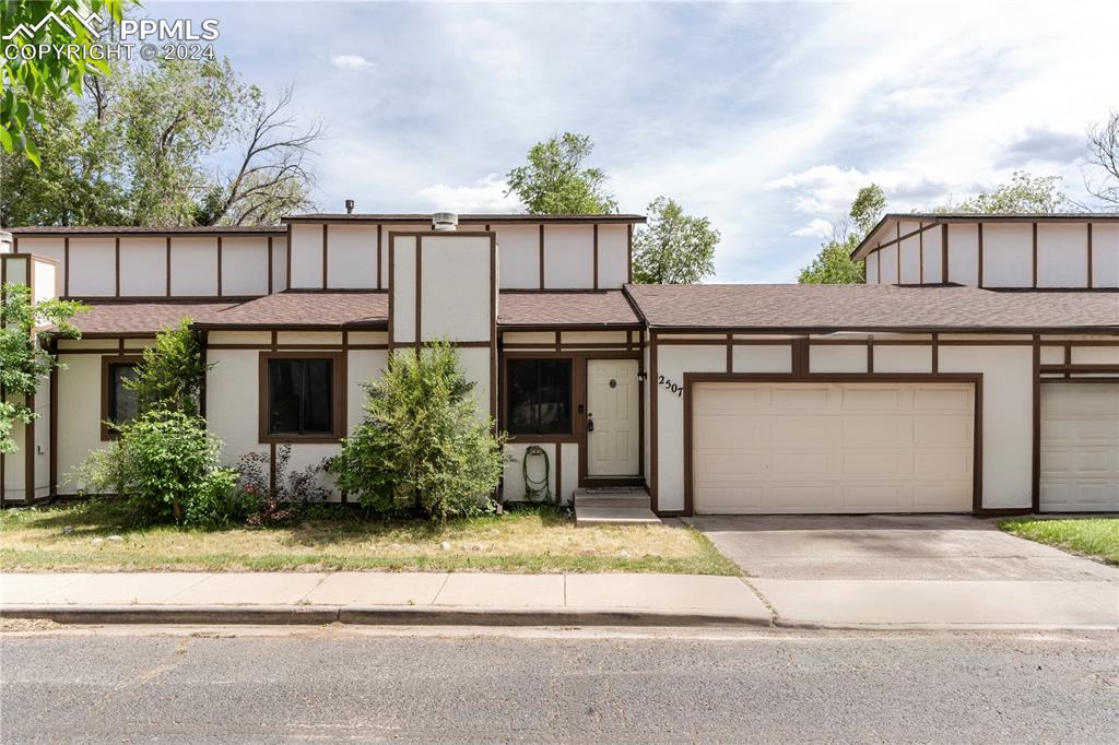 View of front facade featuring a garage