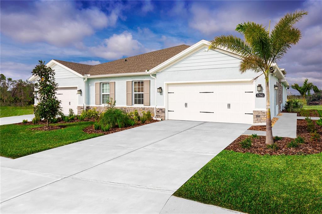 a front view of a house with a garden and yard