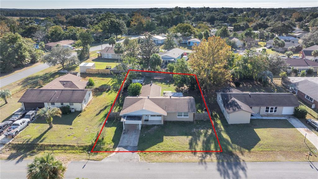 an aerial view of a house with a swimming pool