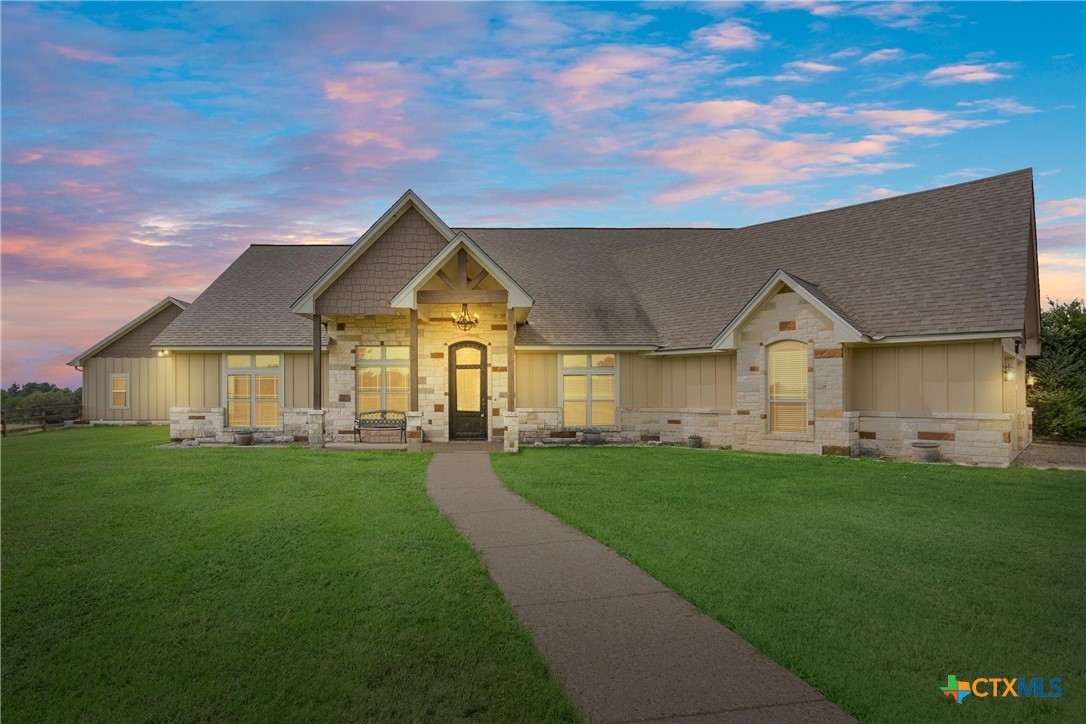 a front view of house with yard and green space