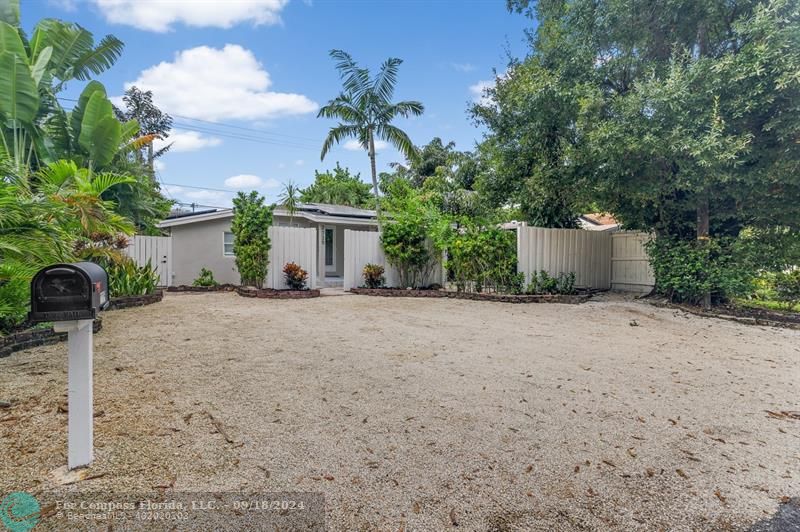 a front view of a house with a yard and a garage