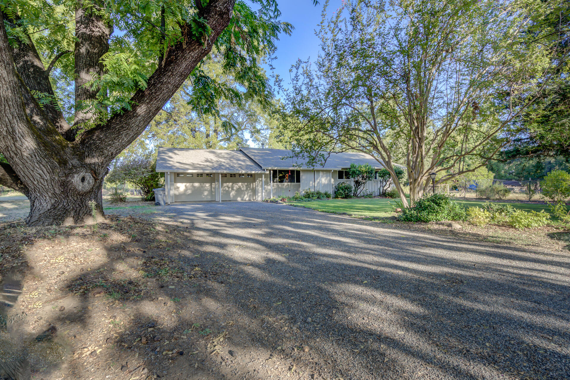 a view of a house with a tree and a yard