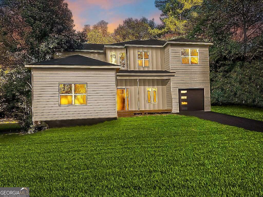 a front view of a house with a yard and garage