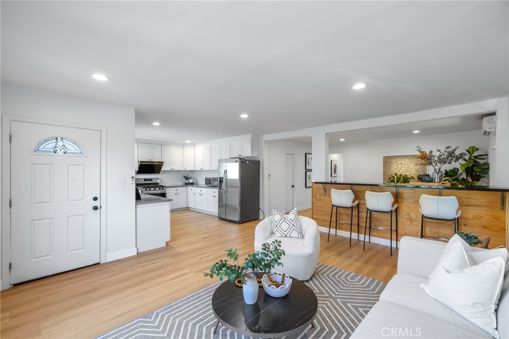 a living room with furniture and kitchen view