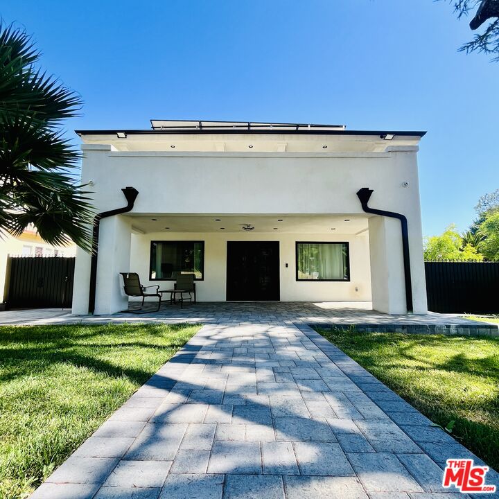 a view of a house with a yard and swimming pool