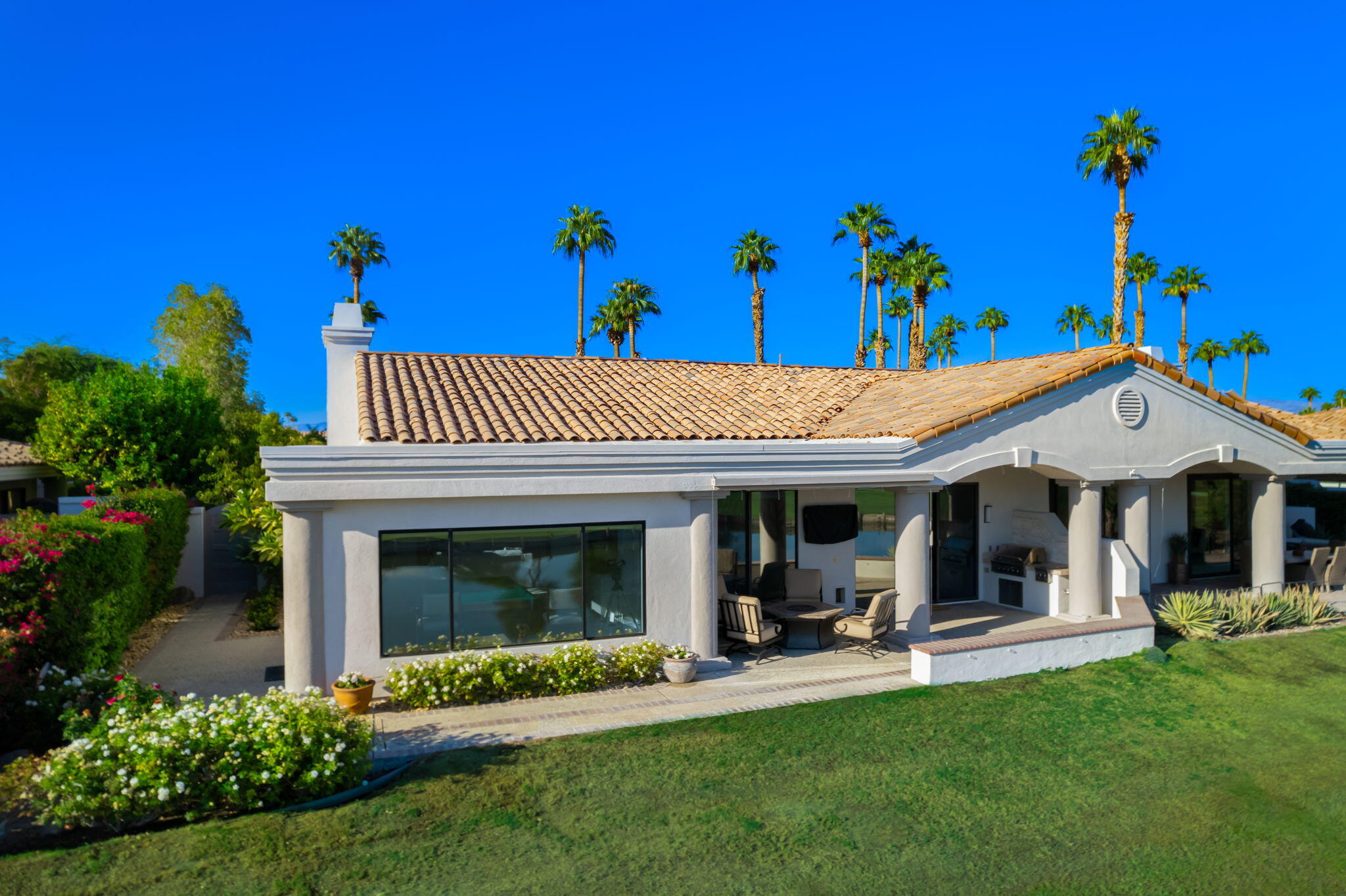 a view of a house with a porch and a garden