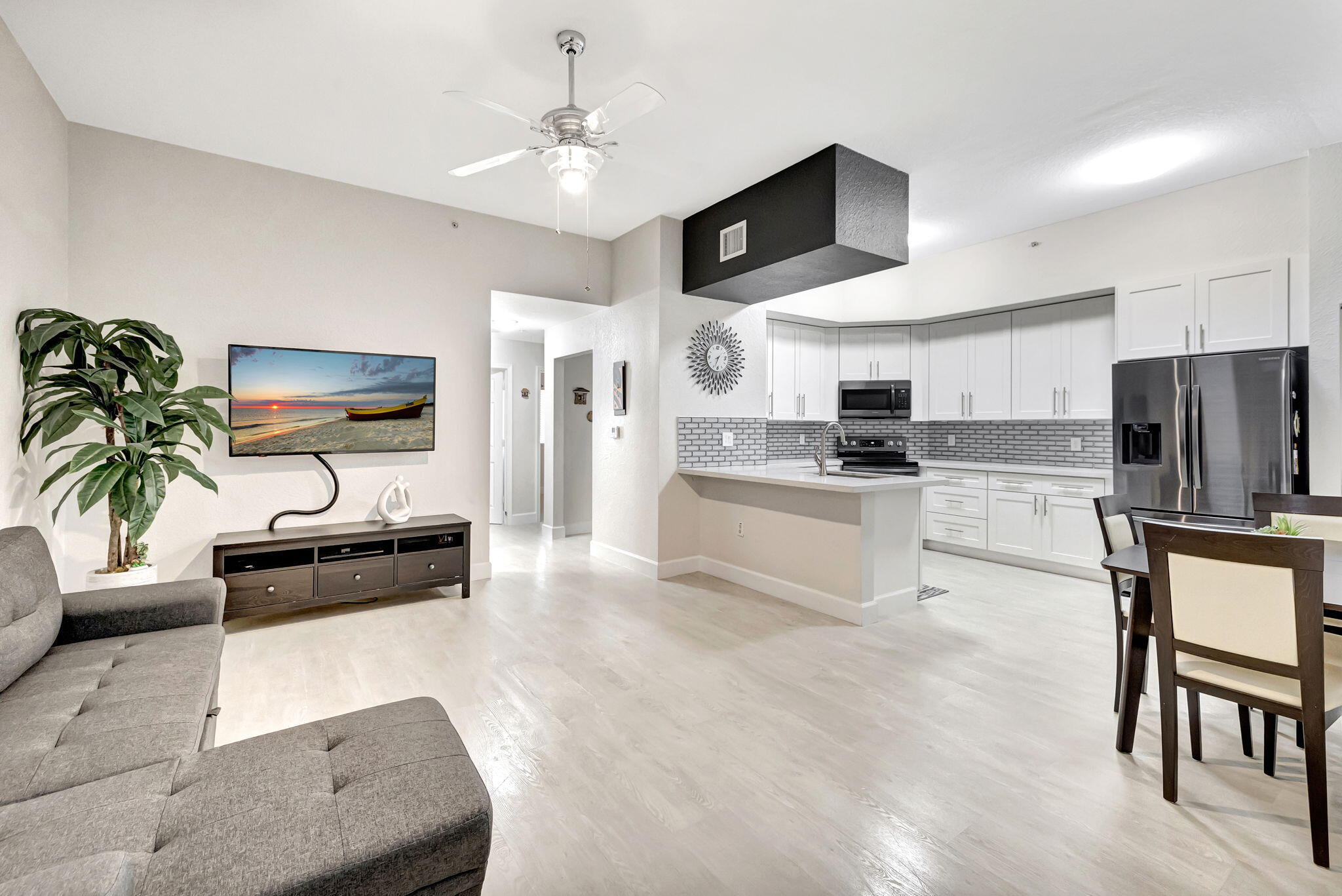 a kitchen with stainless steel appliances kitchen island granite countertop a refrigerator and a stove top oven