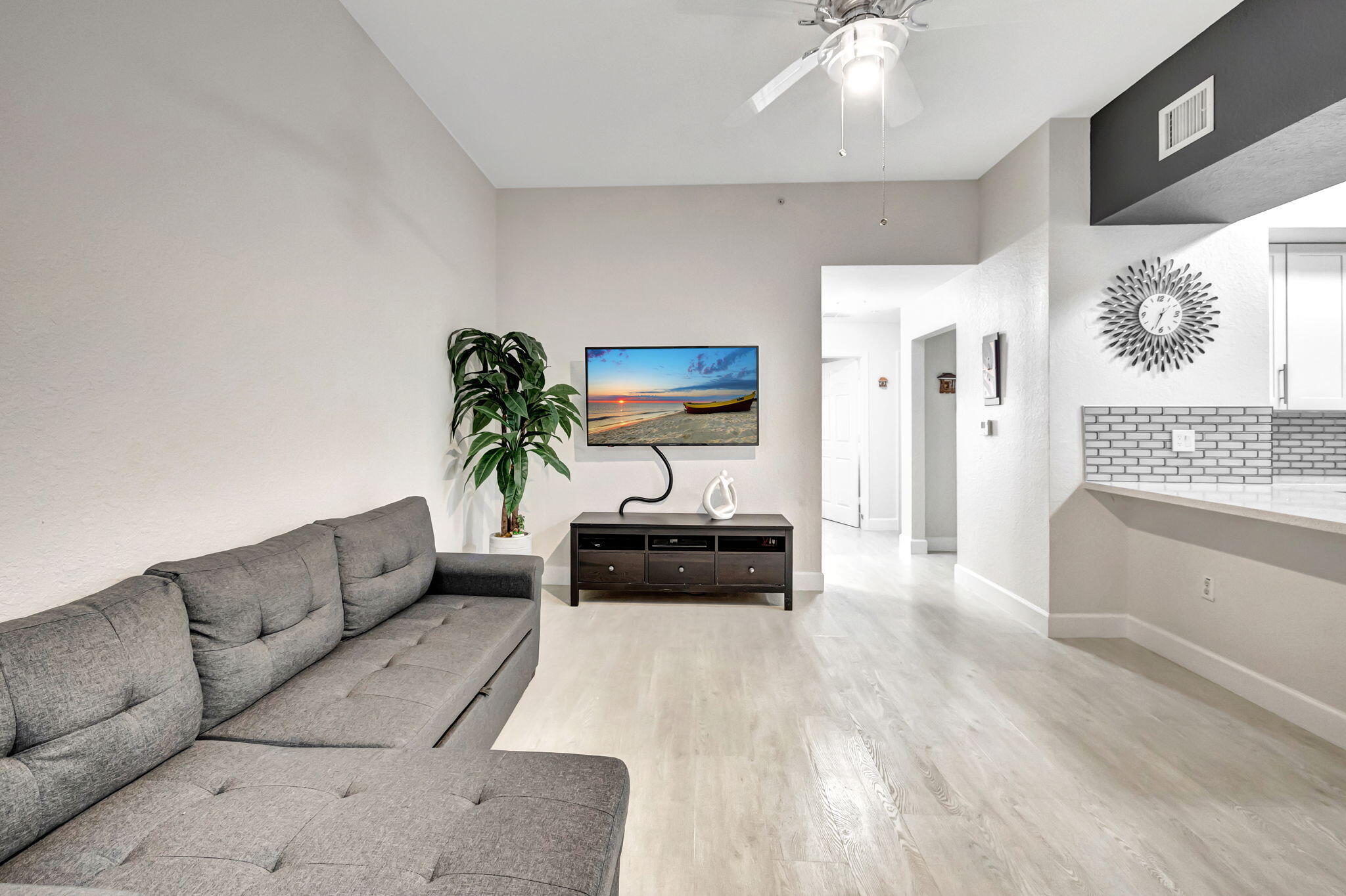 a living room with furniture and a chandelier