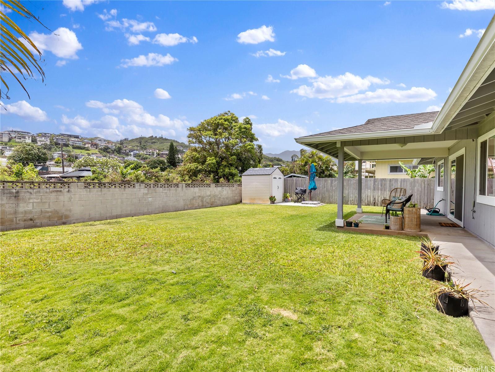 a swimming pool with outdoor seating and yard