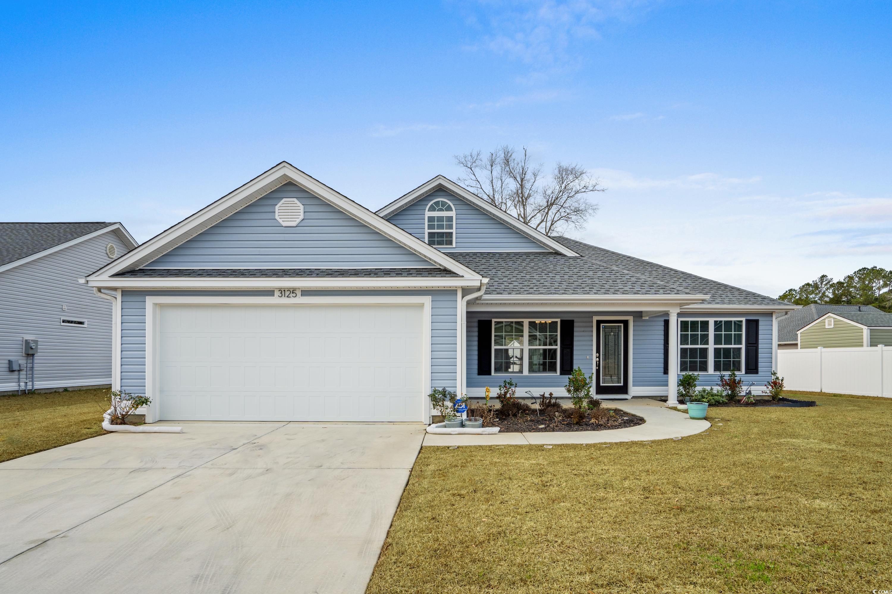 Ranch-style home with a front yard and a garage