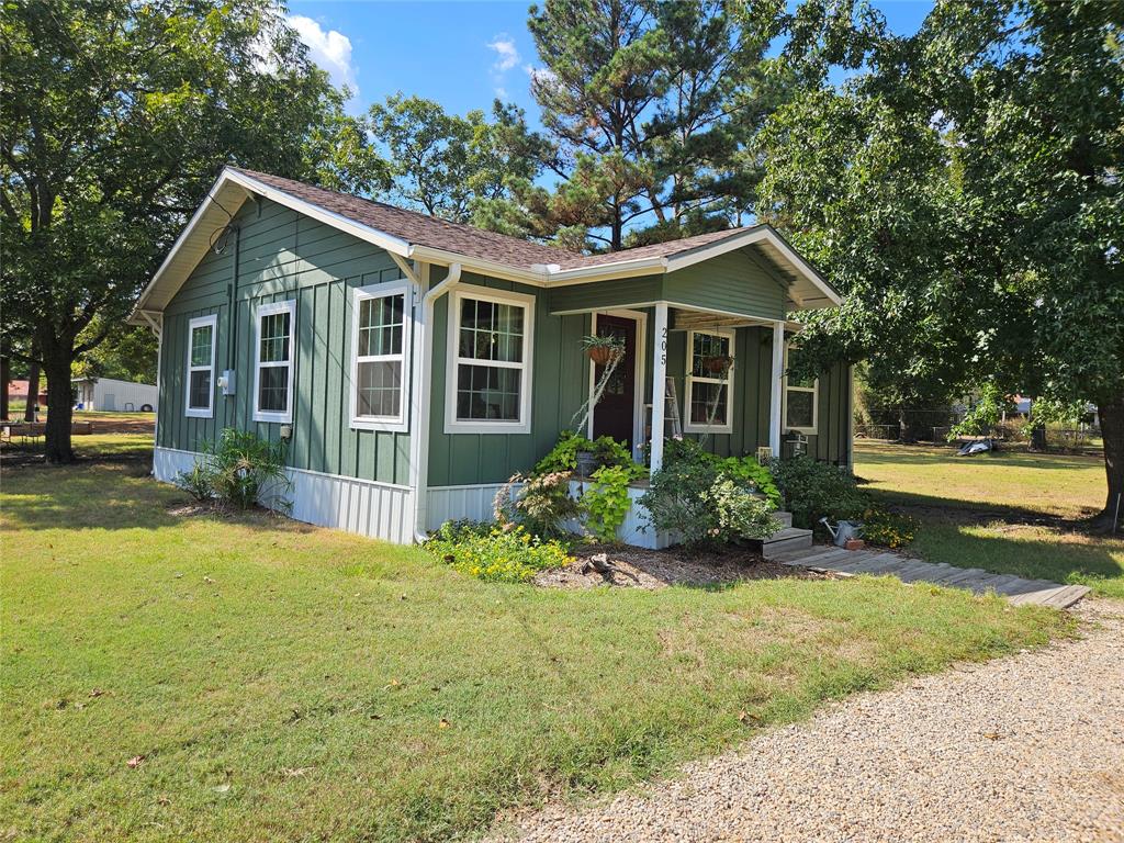 a front view of house with yard and green space