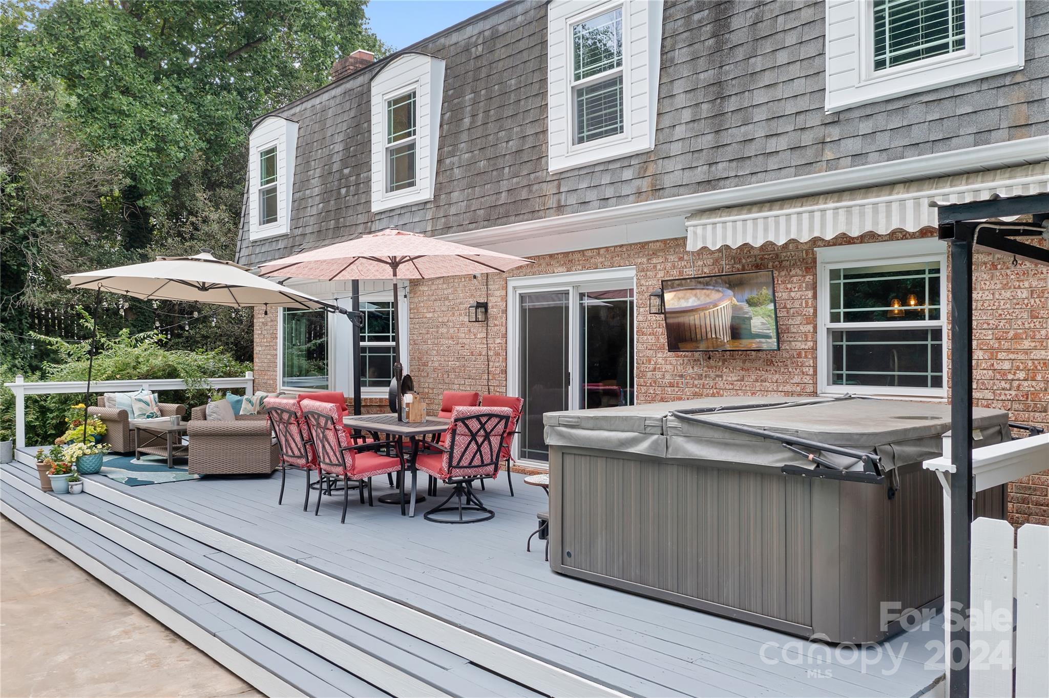 a view of a patio with a dining table and chairs under an umbrella