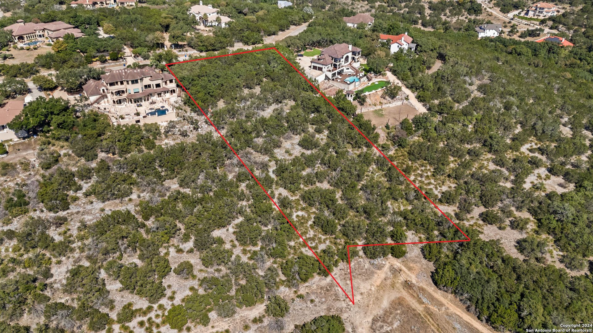 an aerial view of residential house with yard