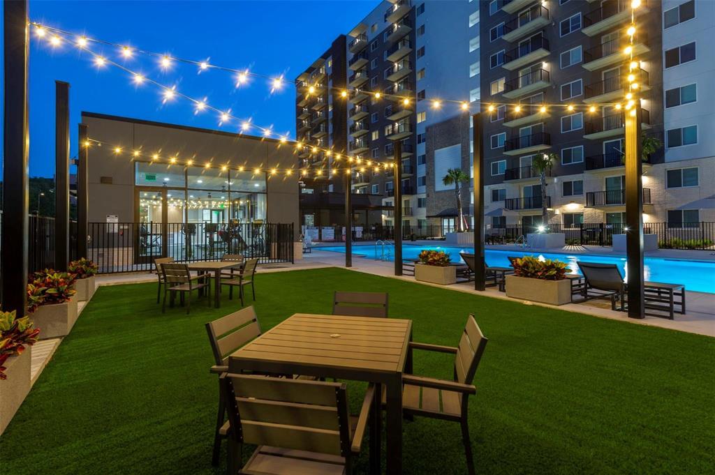 a view of a chairs and table in patio with a yard