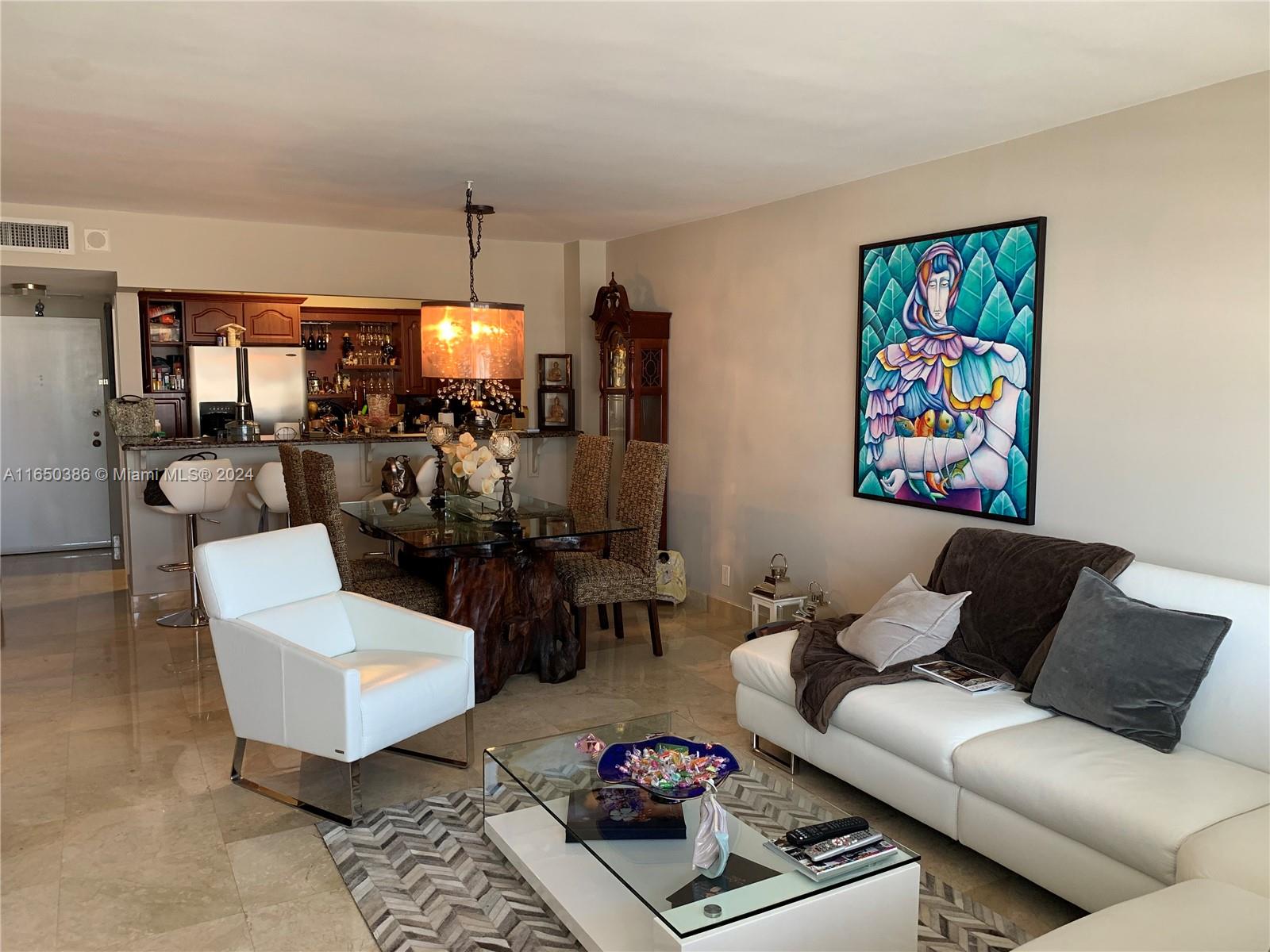 a living room with furniture a rug and a chandelier