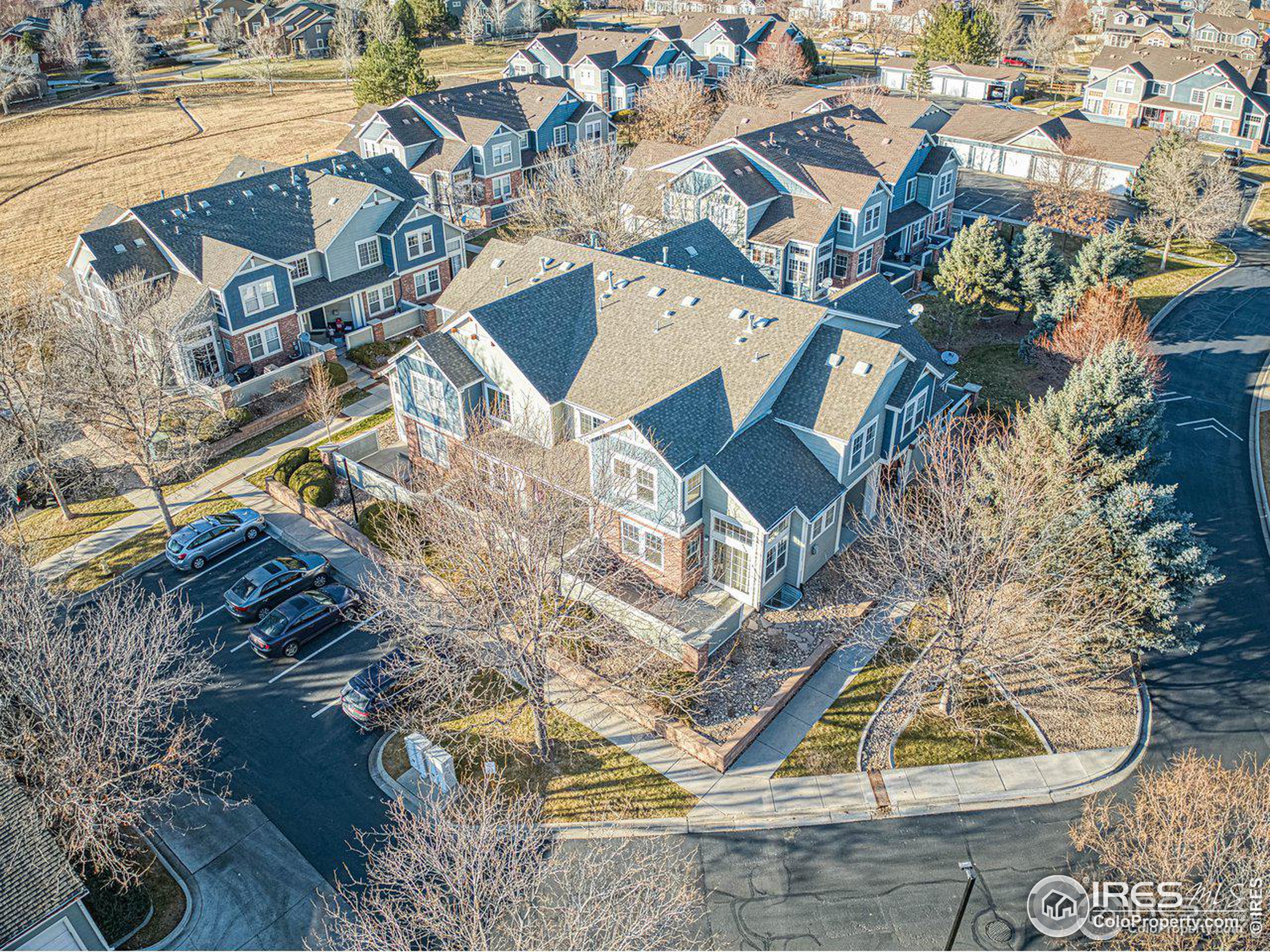 an aerial view of a house with a yard and lake view