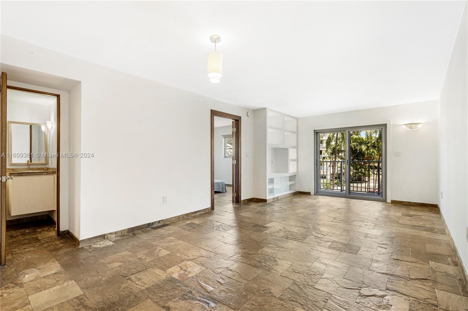 an empty room with windows and closet