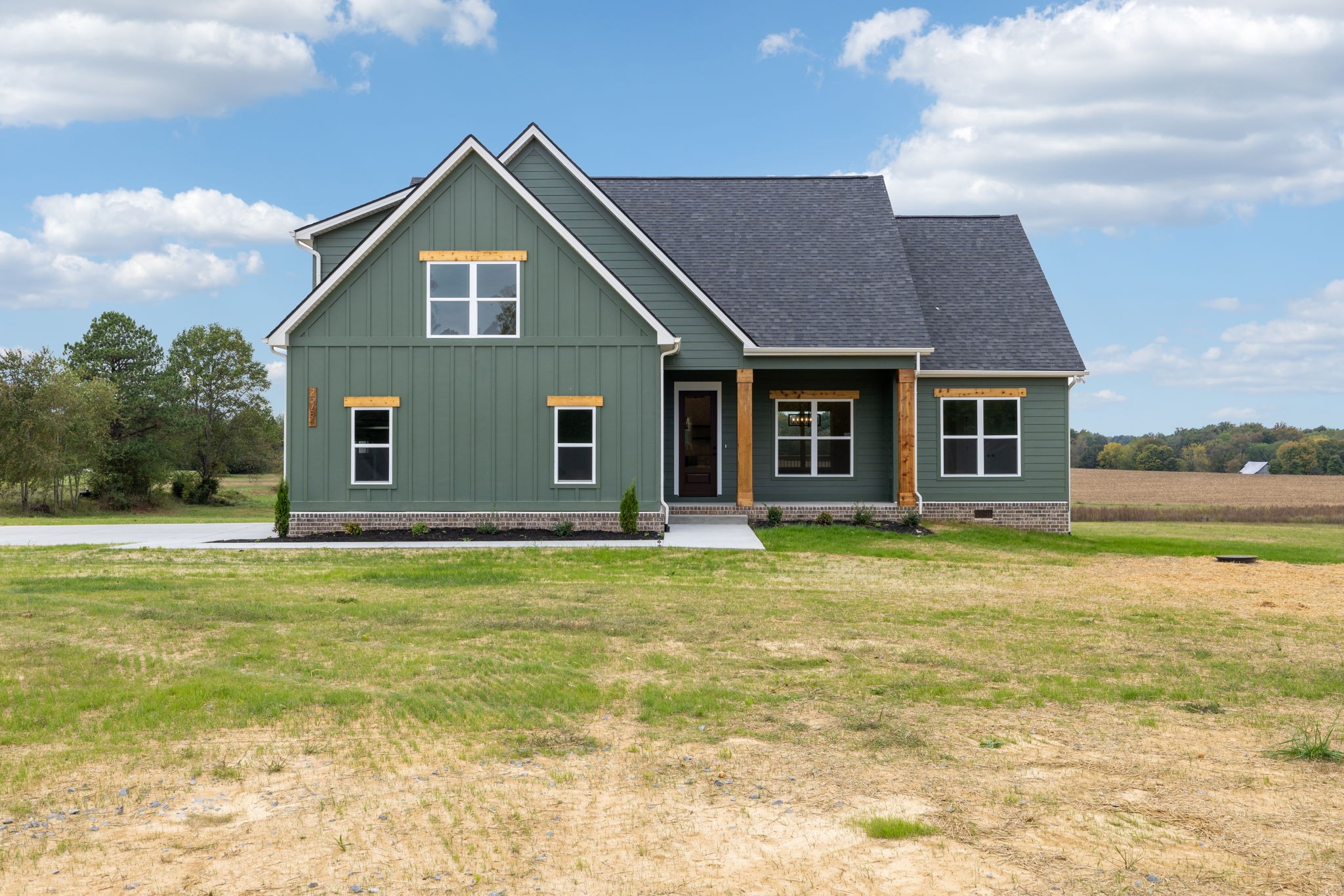 a front view of a house with a garden