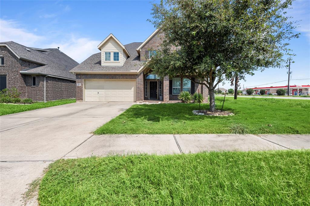 a front view of a house with a yard and garage