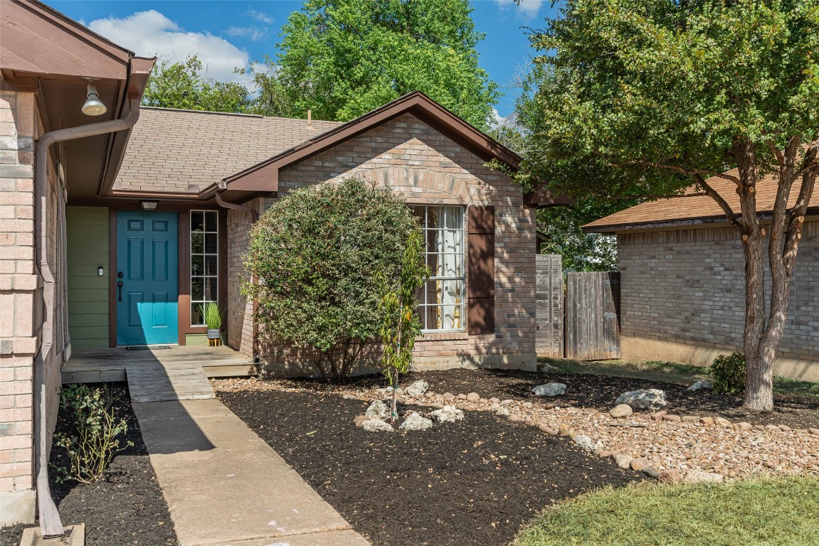 a front view of a house with garden