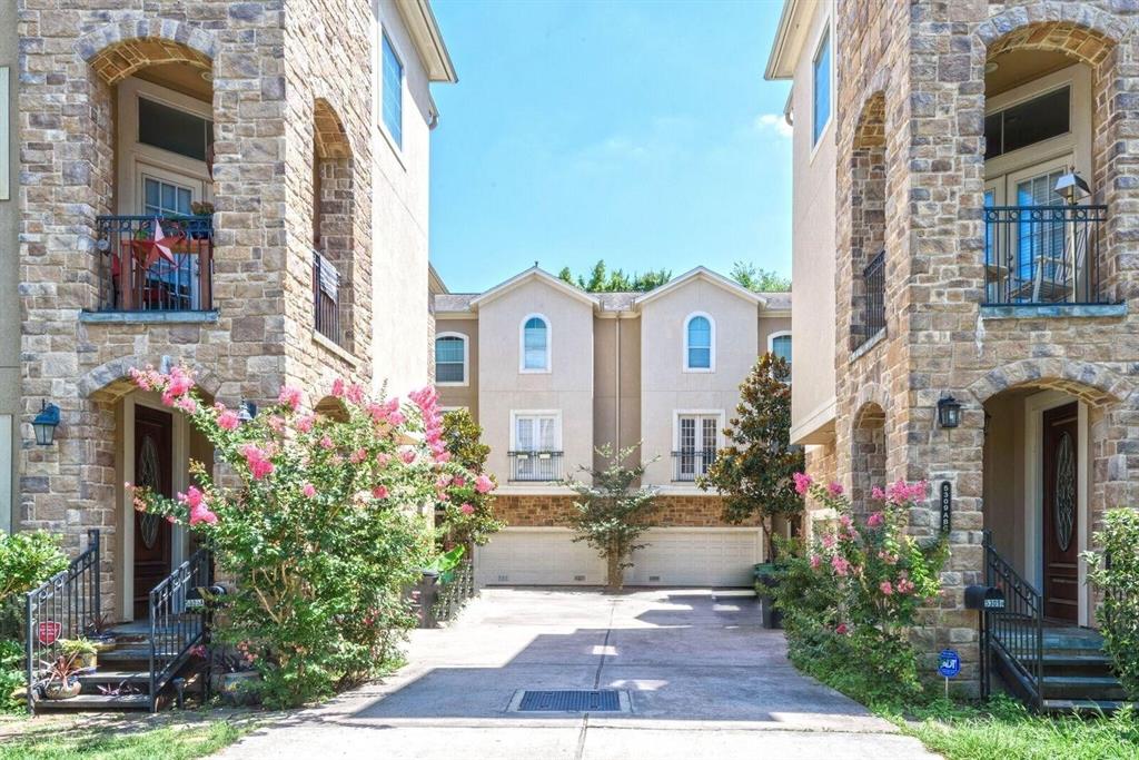 a front view of a multi story residential apartment building with yard