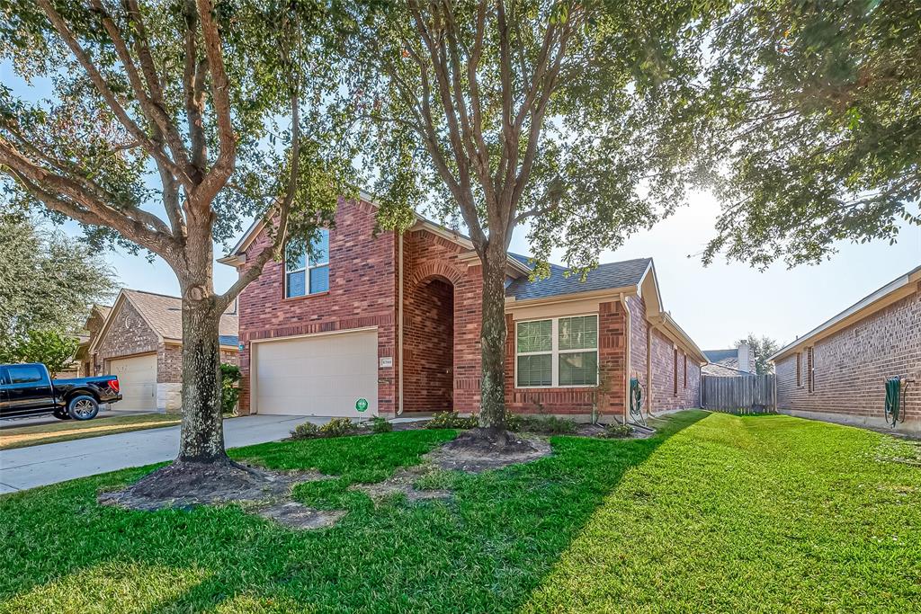 a view of a house with a tree in a yard