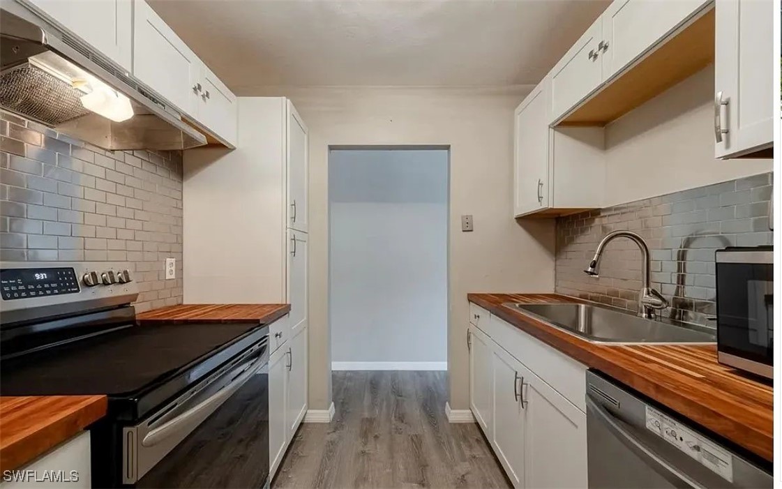 a kitchen that has a sink and a stove