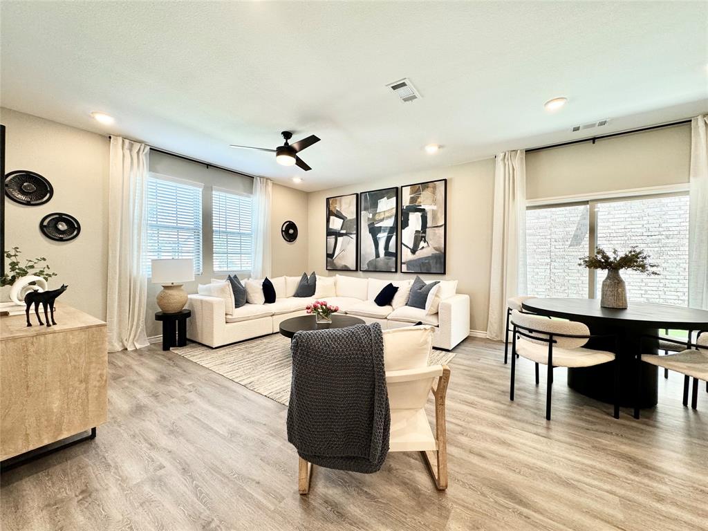 a living room with furniture and wooden floor