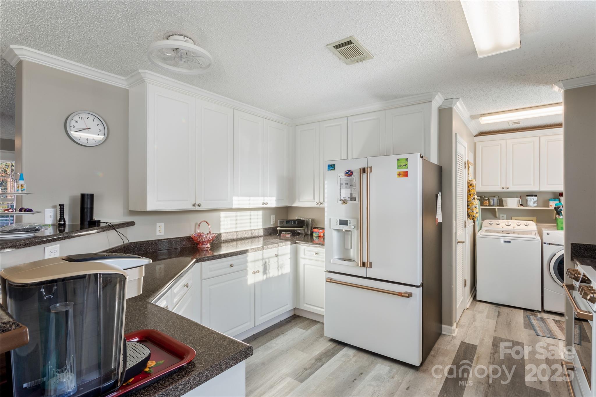 a kitchen with a sink a refrigerator a washer and dryer