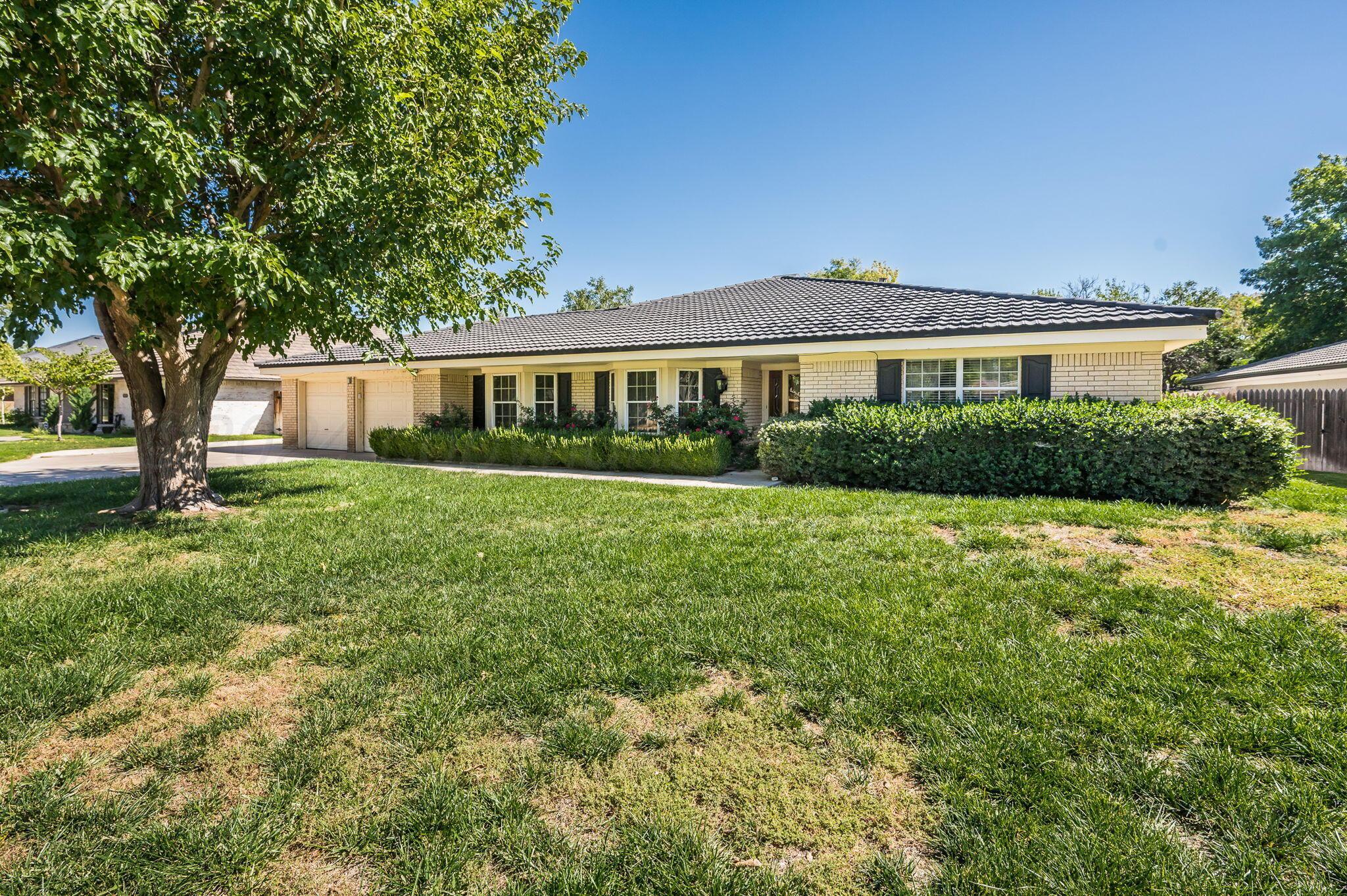 a view of house with a yard