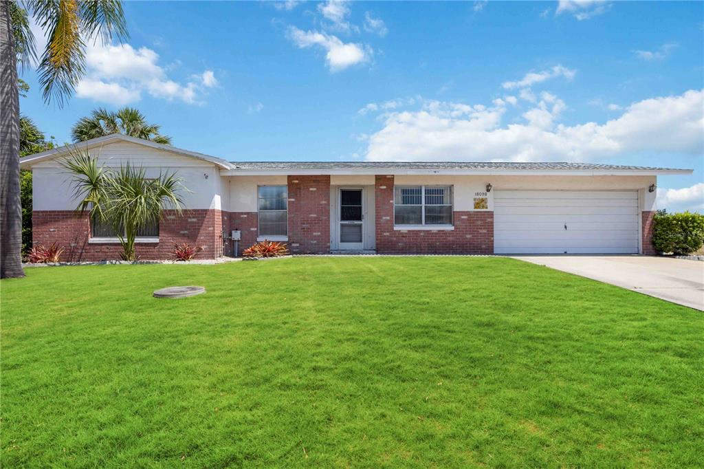 a front view of house with yard and outdoor seating