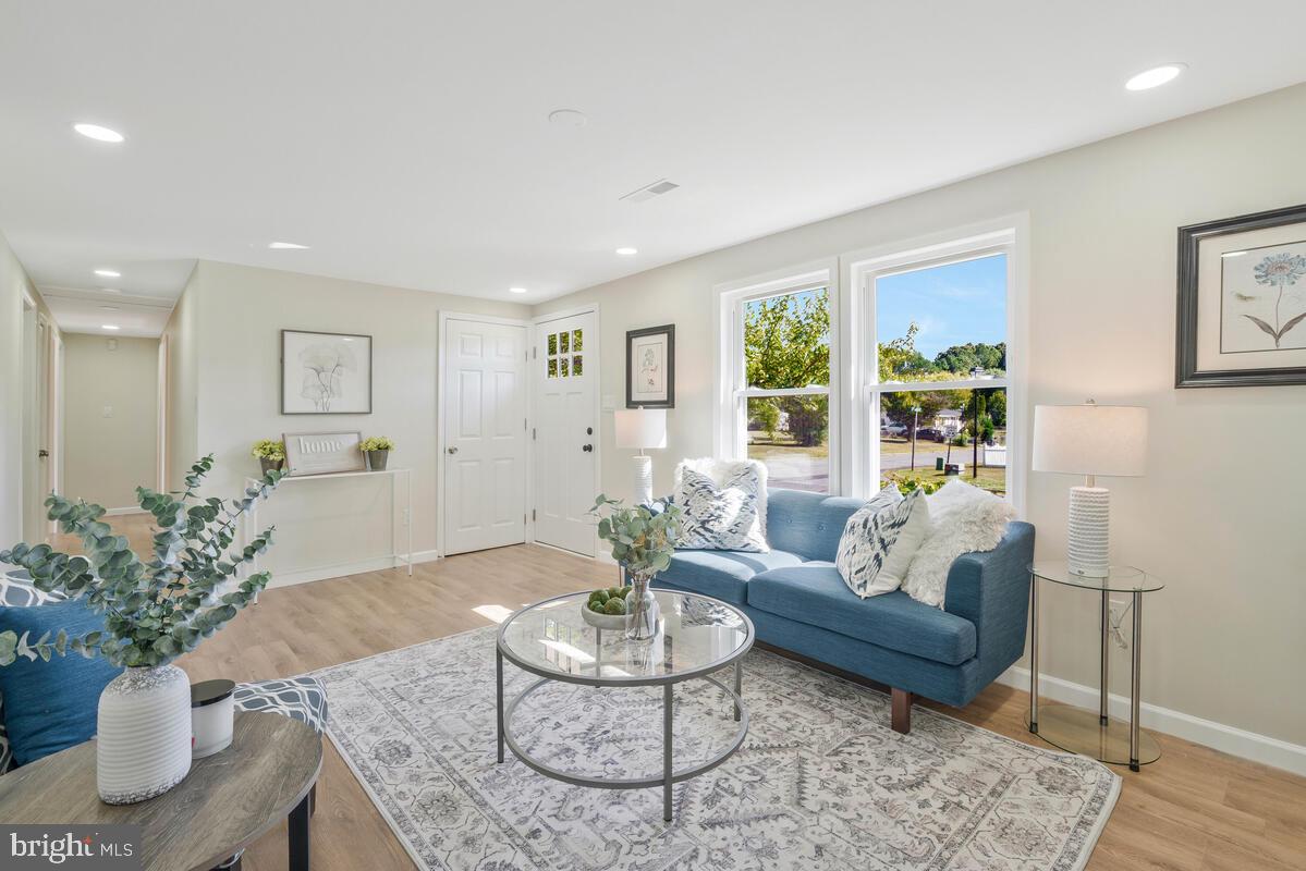 a living room with furniture potted plant and a window