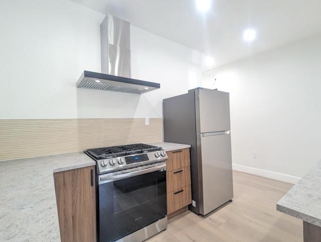 a kitchen with stainless steel appliances a stove and a refrigerator