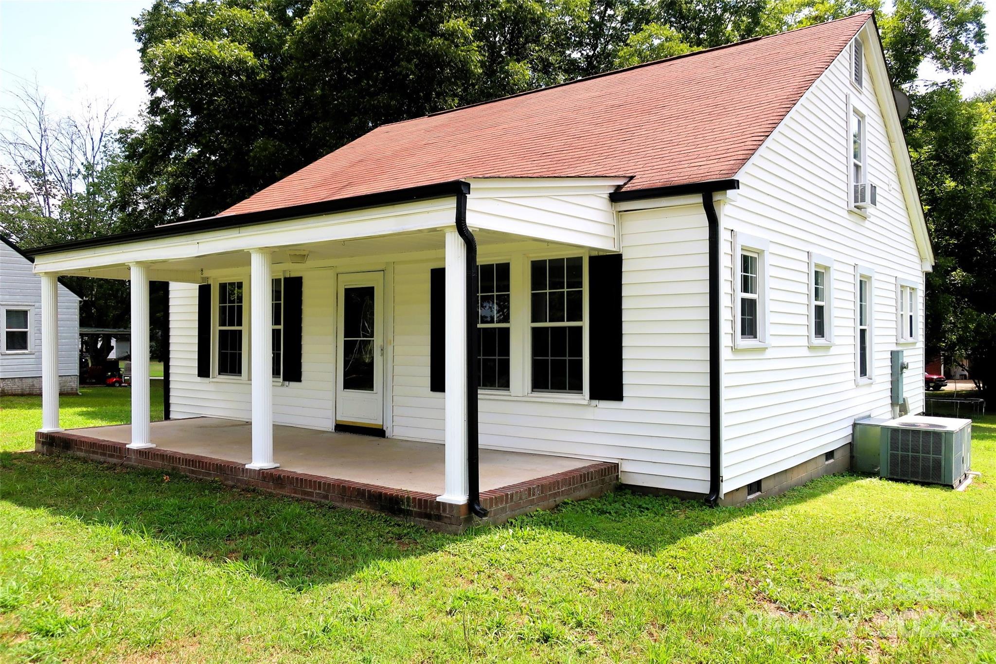 a view of a white house with a yard