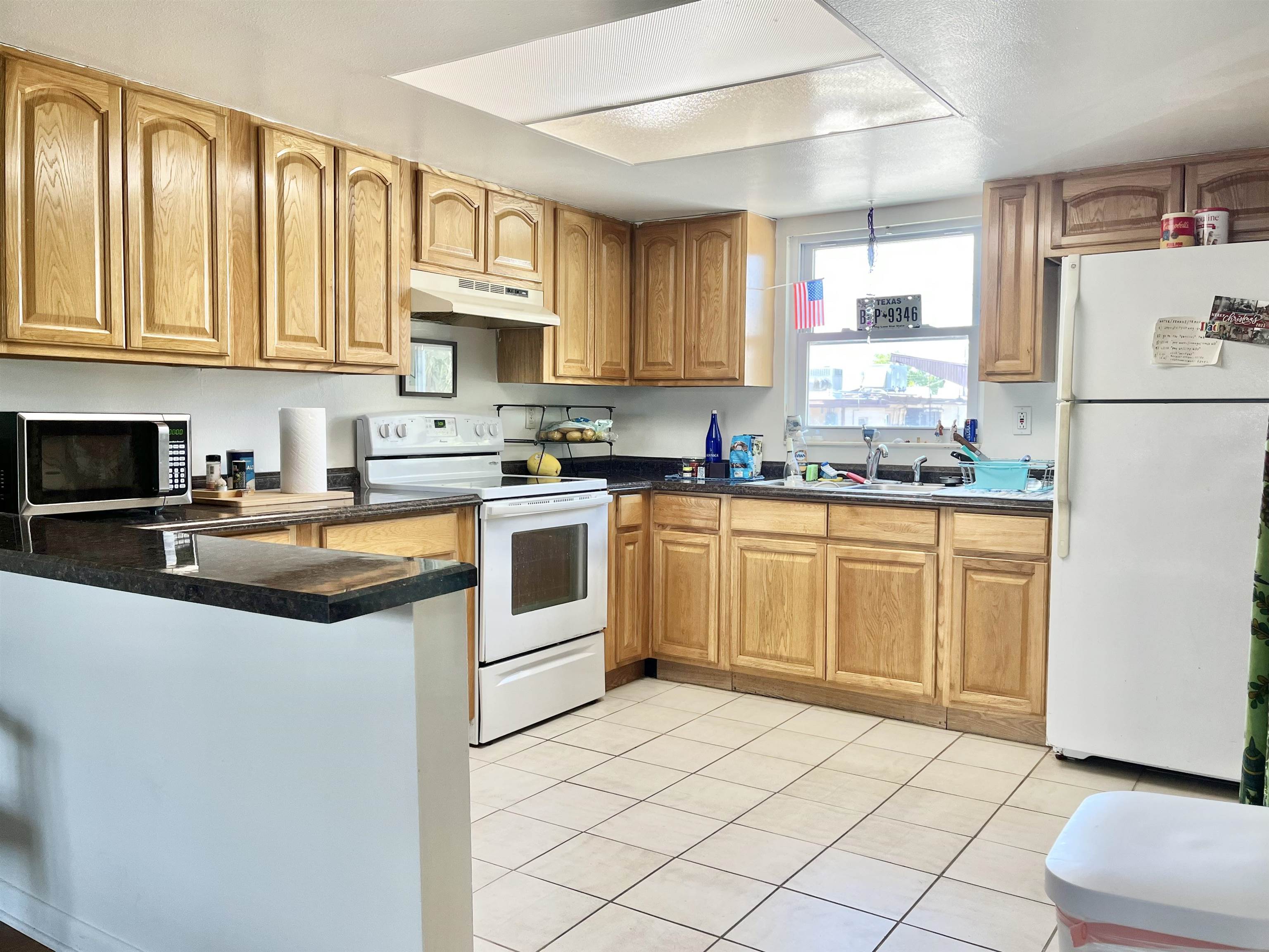 a kitchen with a sink a stove a refrigerator and cabinets