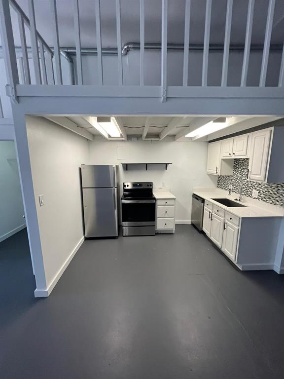 a kitchen with stainless steel appliances a stove and cabinets