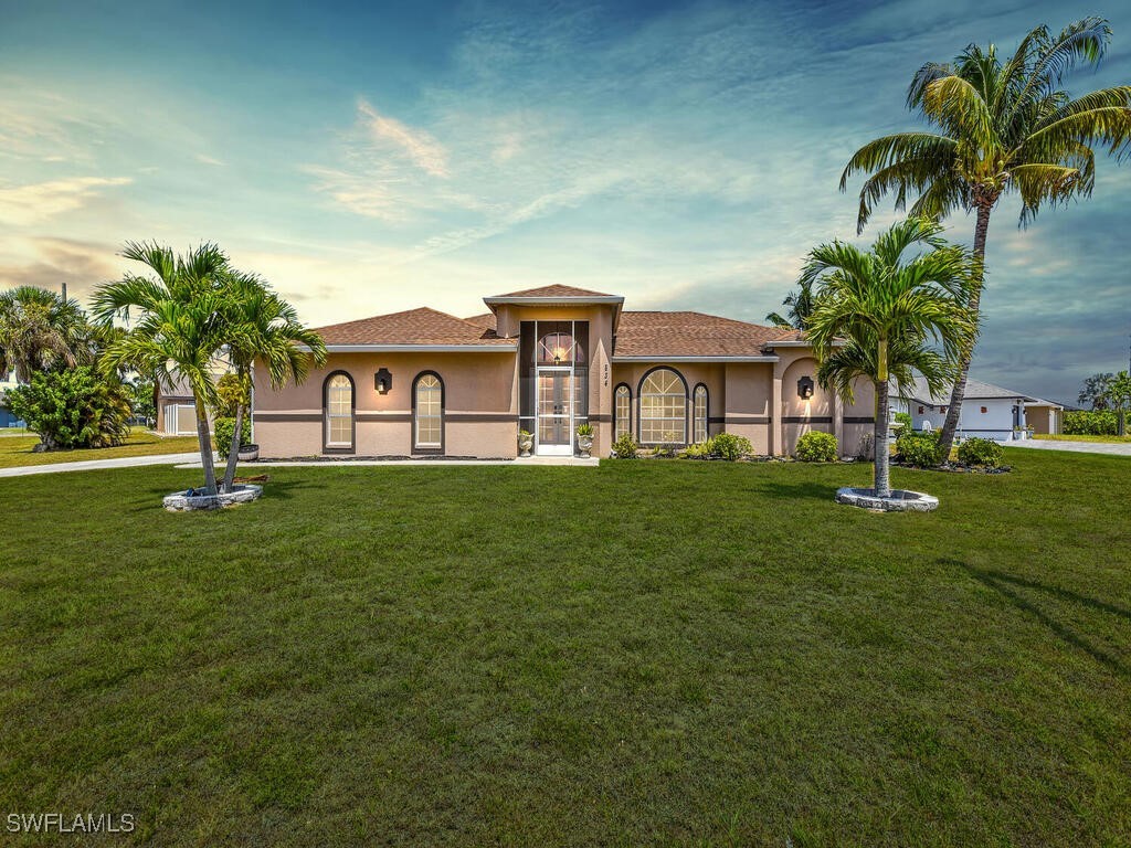 a front view of a house with a garden