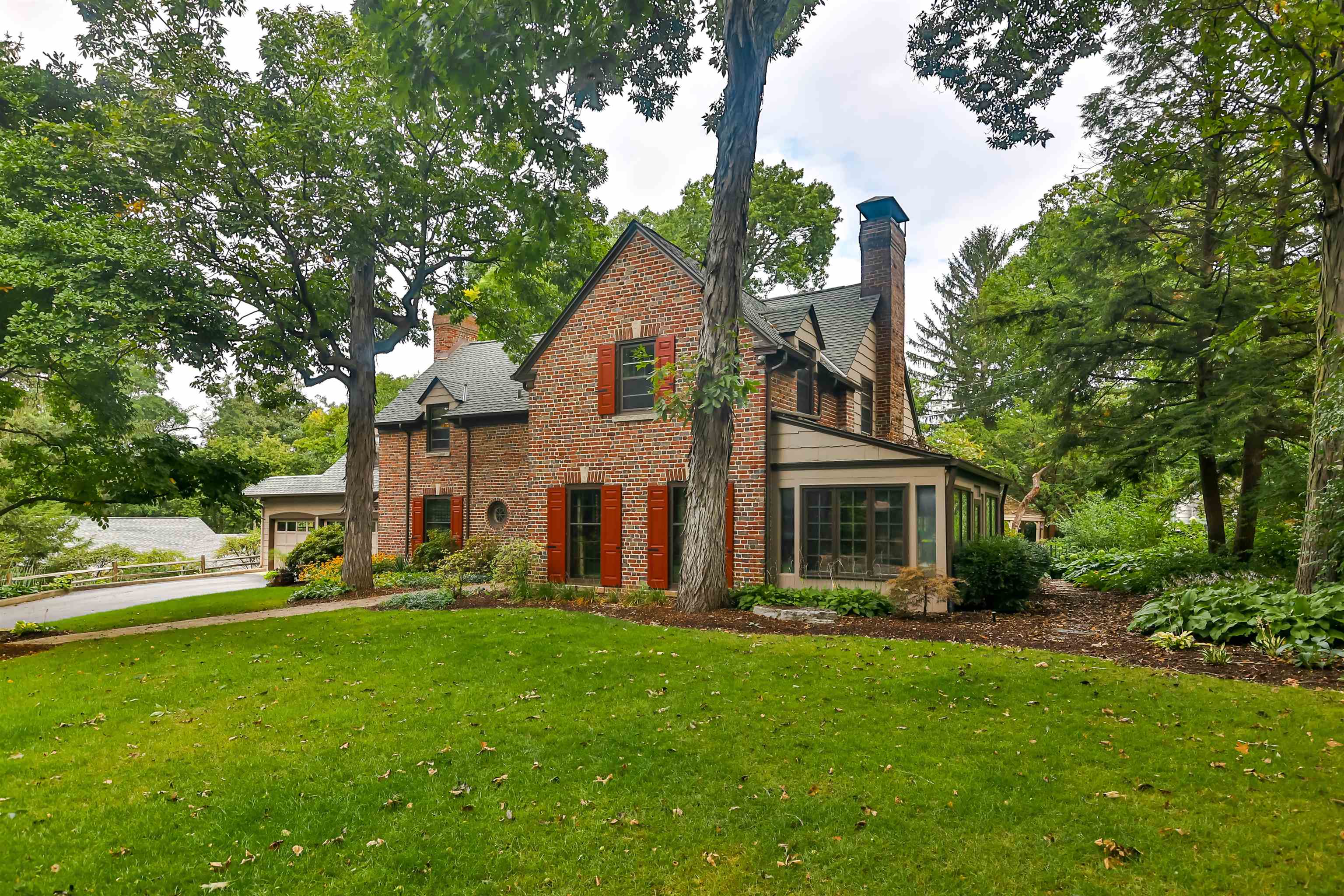 a front view of house with yard and green space