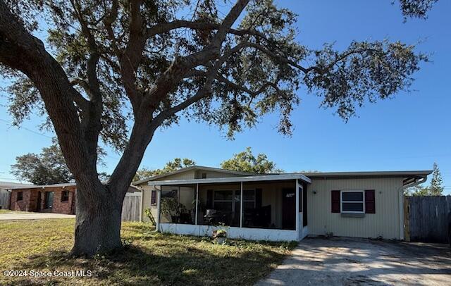 a view of a house with a tree and a yard