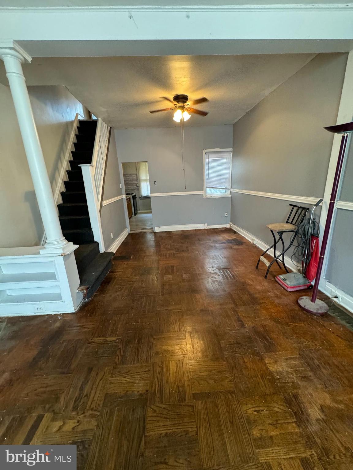 a view of a livingroom with wooden floor and stairs