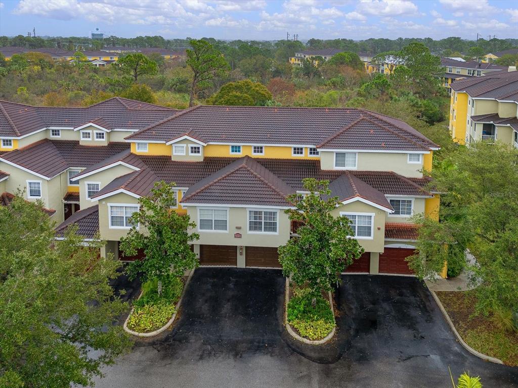 an aerial view of a house with garden space and lake view