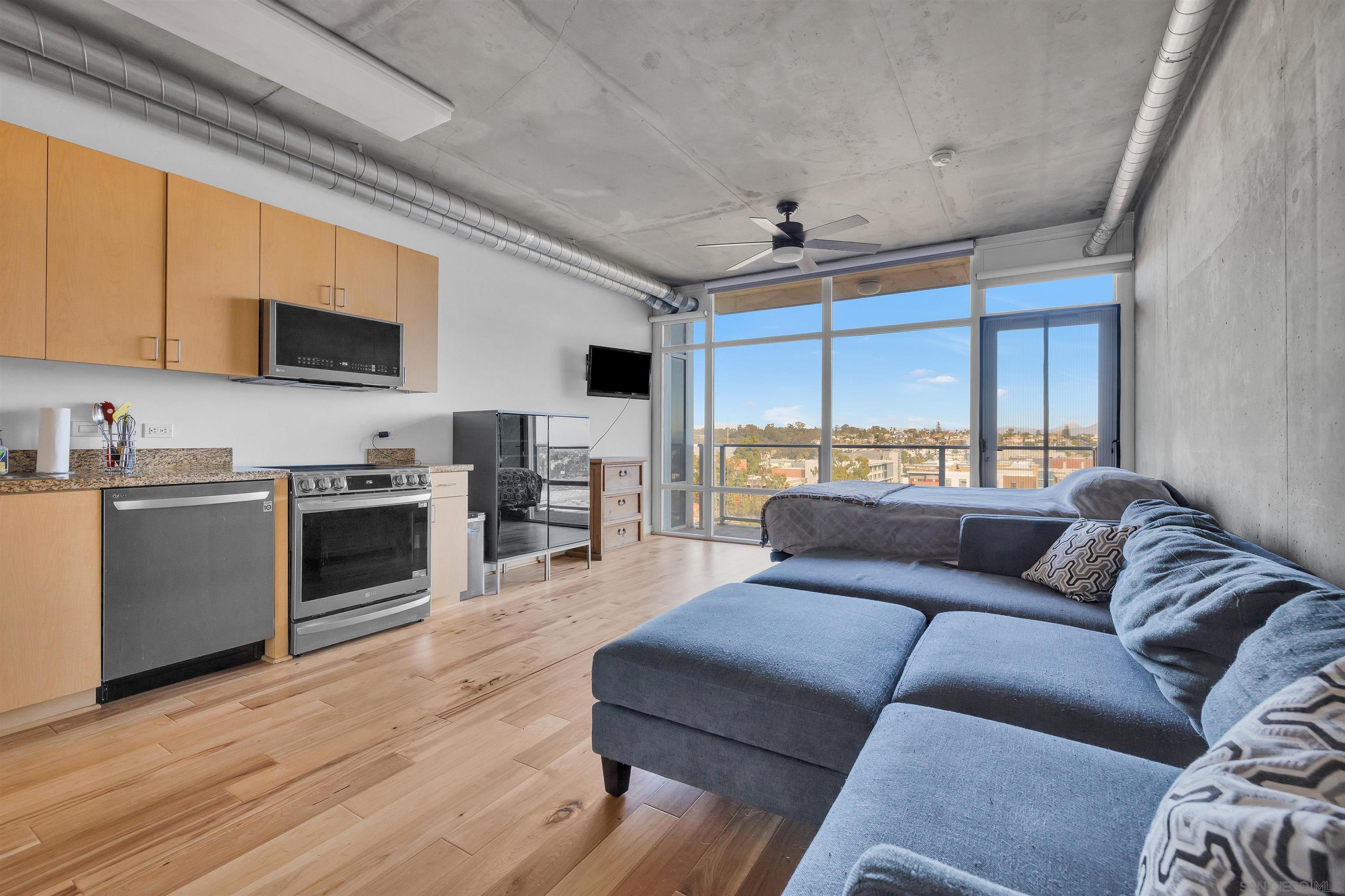 a living room with furniture flat screen tv and a fireplace