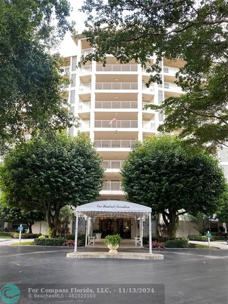 a front view of a building with a garden