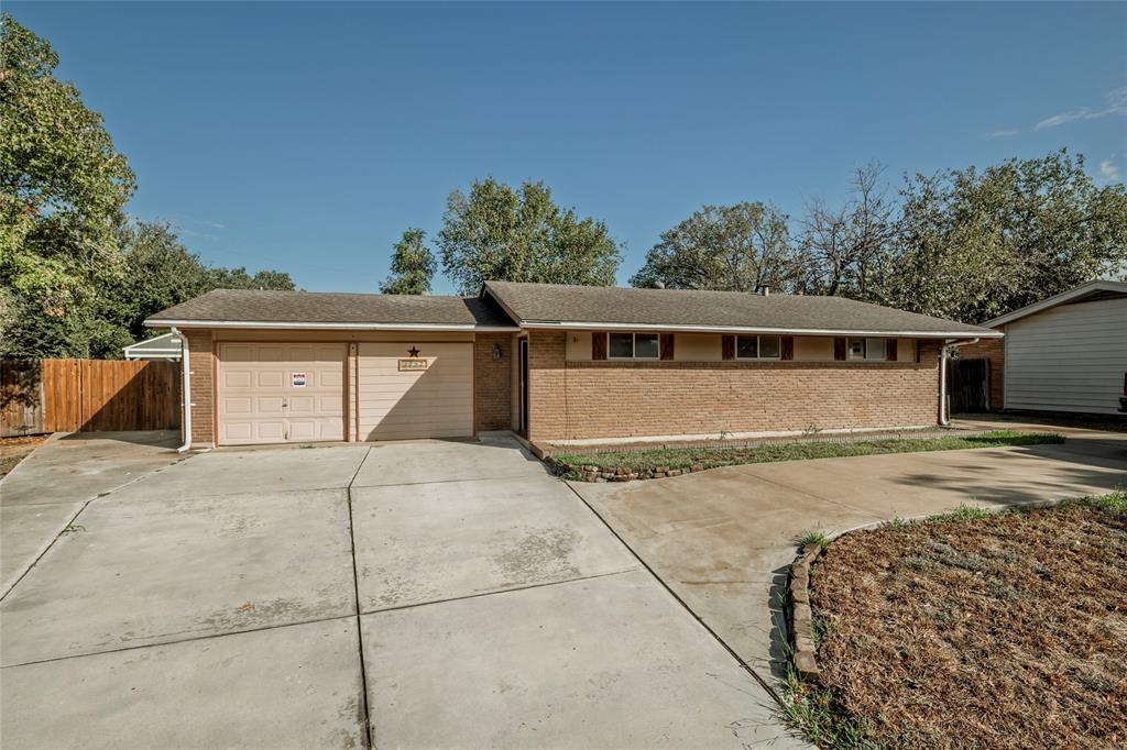 a view of house with outdoor space and parking