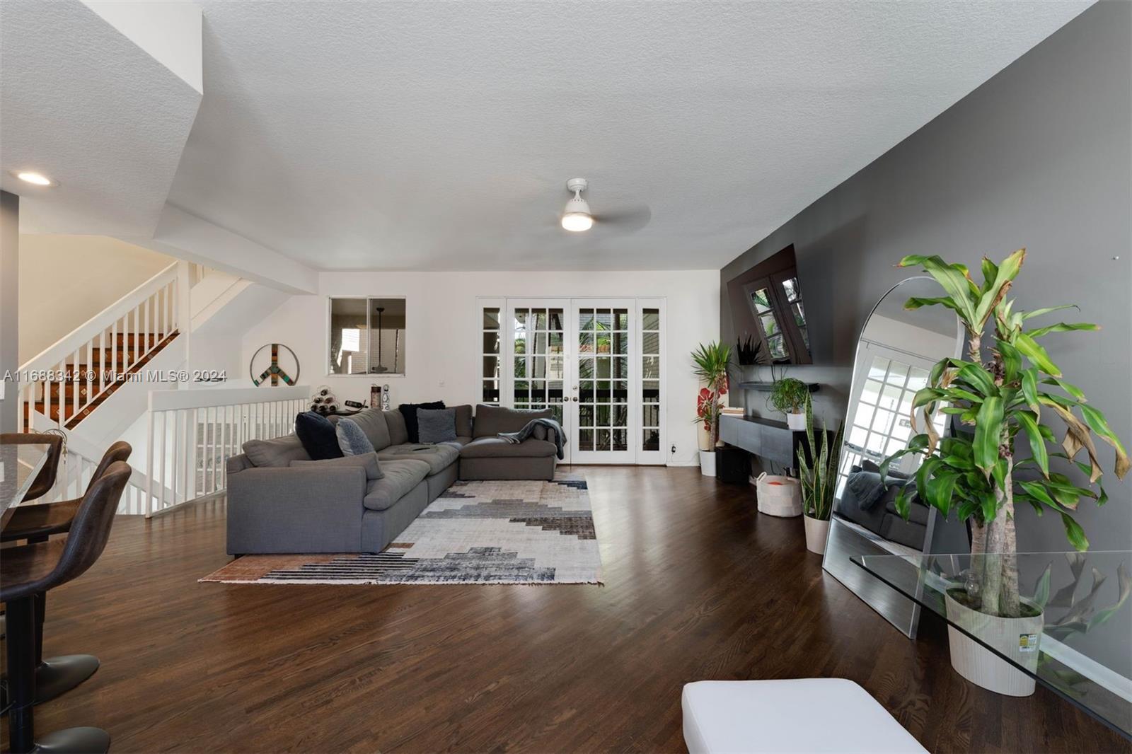 a living room with furniture a fireplace and a potted plant