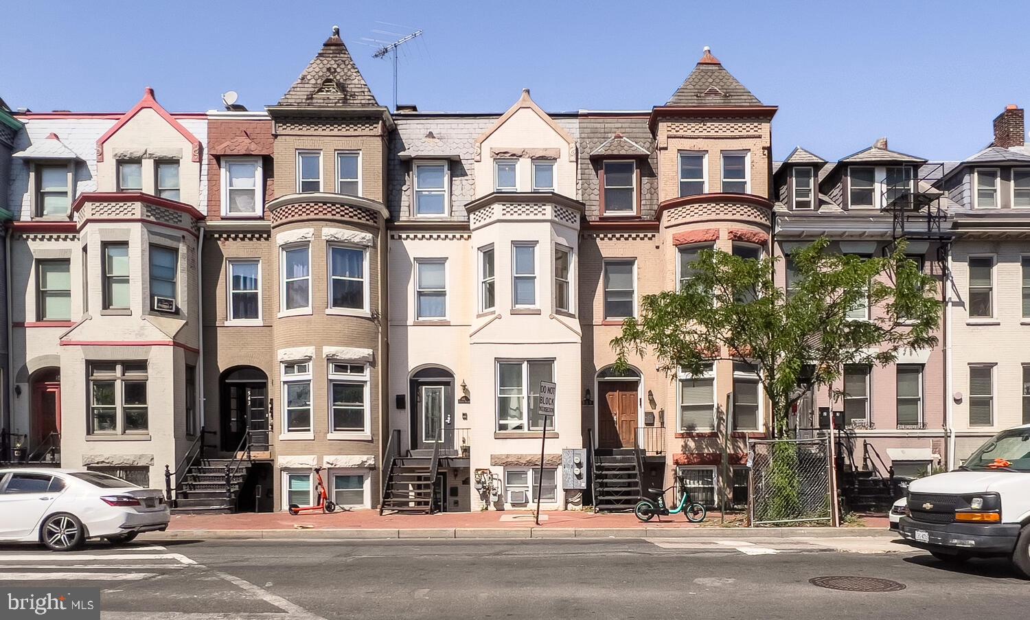 a front view of a residential apartment building with a yard