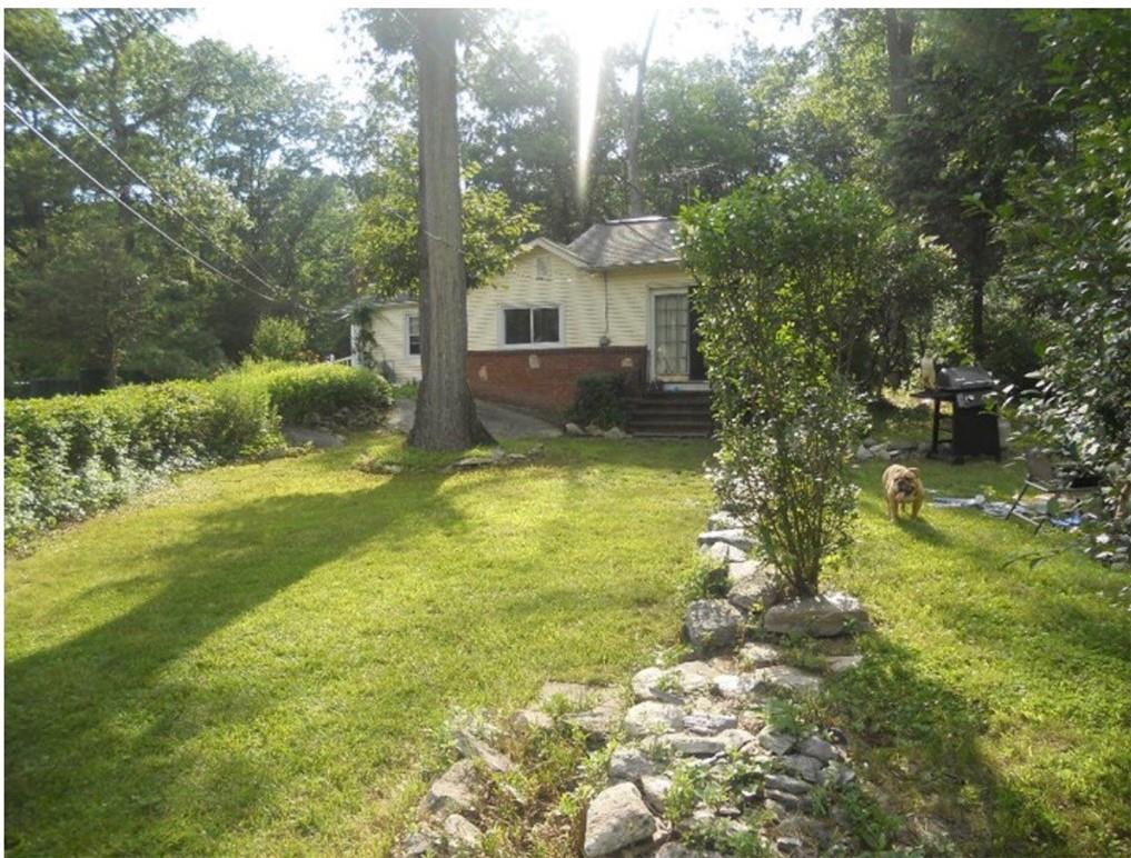 The property is overgrown at this time.  This is an older picture of the yard.