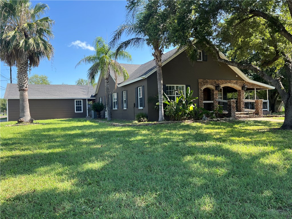 a front view of house with yard and green space